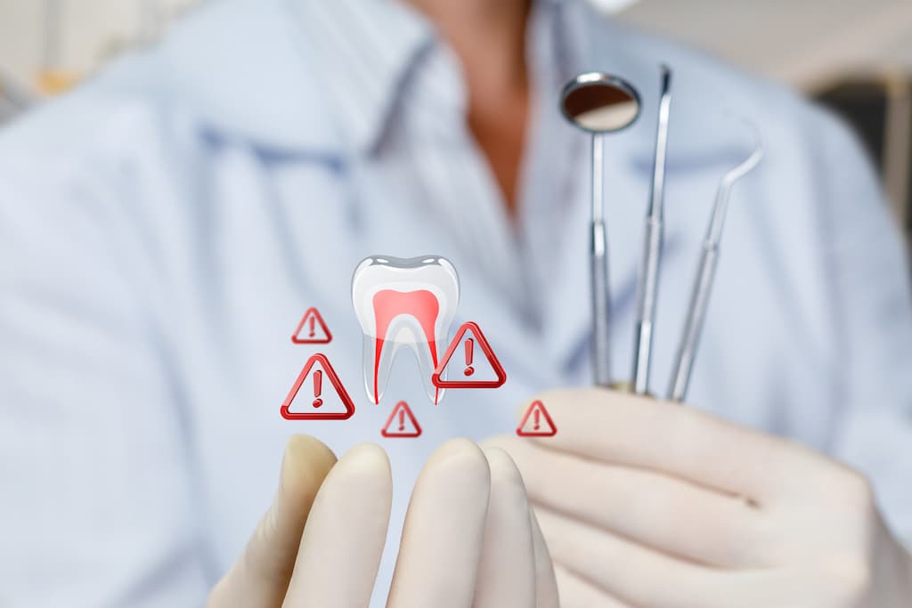 Dentist holding tools with a digital tooth and warning signs overlay.