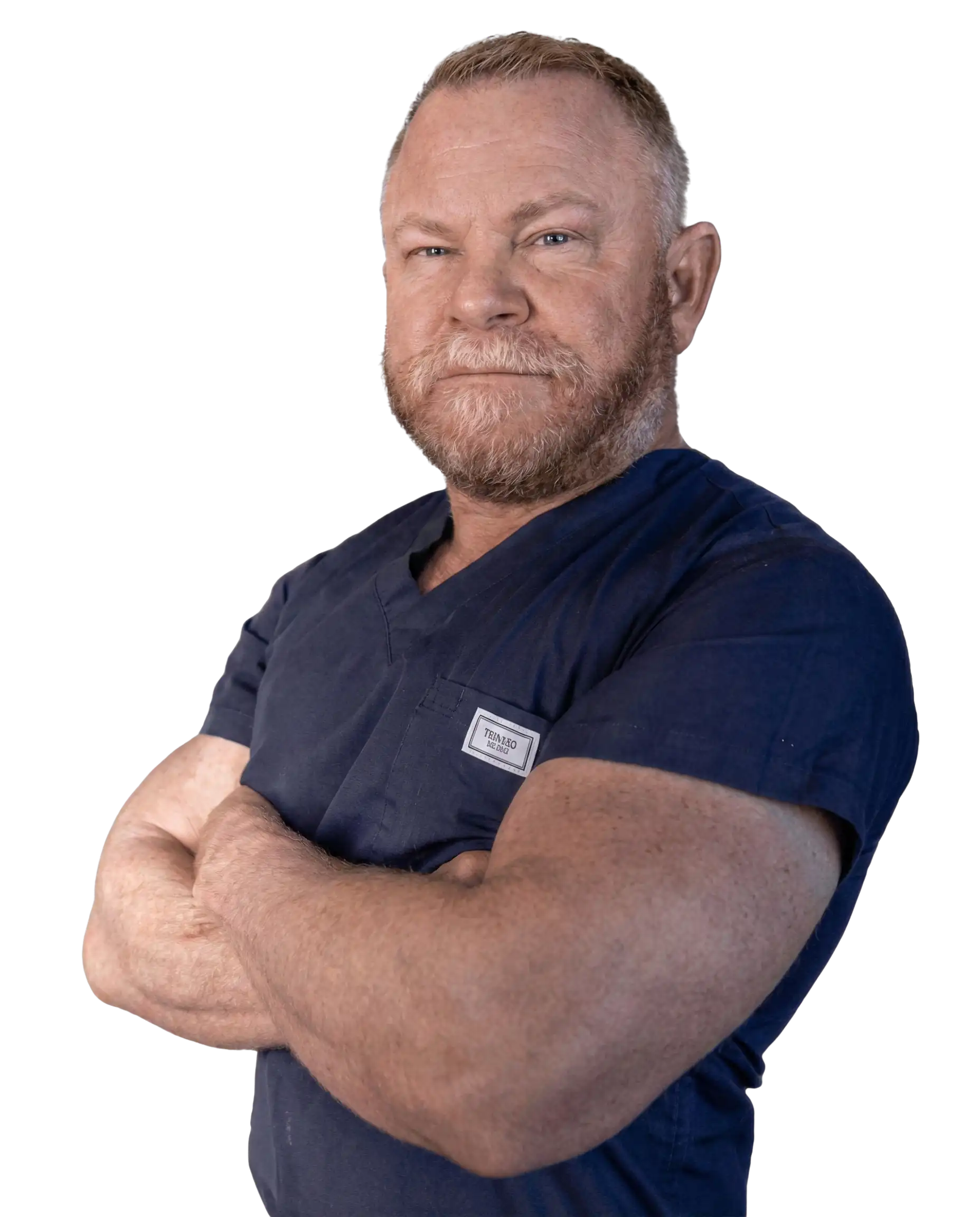 Confident Man in Scrubs with Crossed Arms Man in blue scrubs with arms crossed against a plain background.